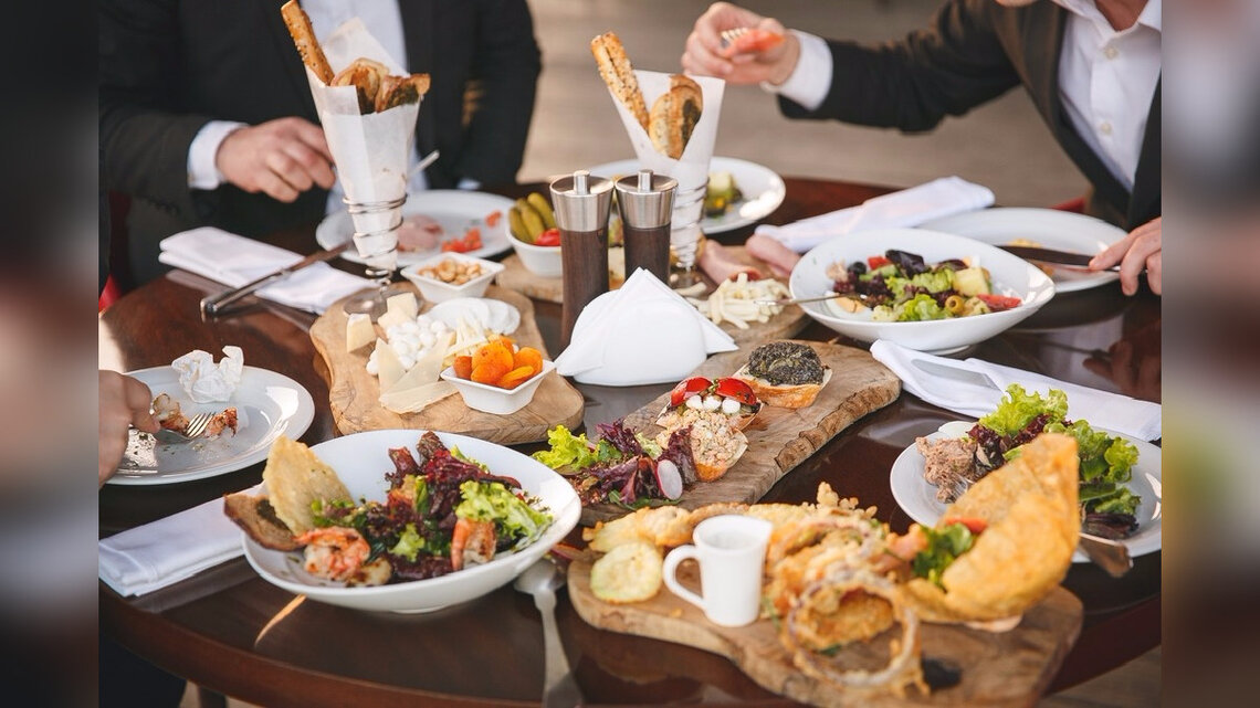 Evento corporativo con banquetería y pantalla de presentación